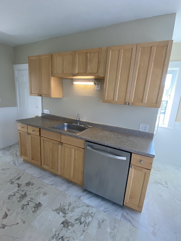 253 Whitwell Street, Unit 2R Quincy, MA 02169 - Photo 2 of 12 a kitchen with granite countertop a sink a stove and a granite counter tops
