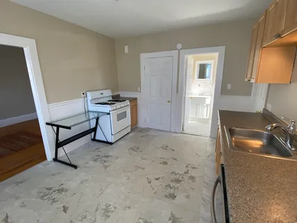a kitchen with a sink stove and a refrigerator