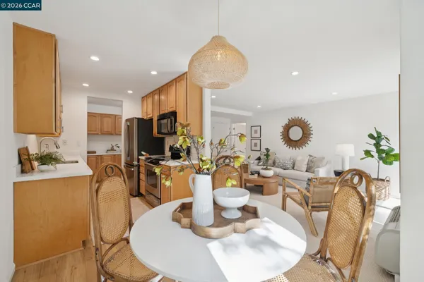 a dining room with wooden floor table and chairs