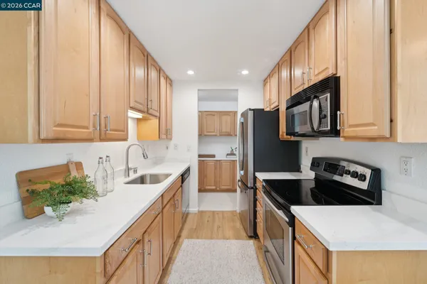 a kitchen with a sink stove and refrigerator