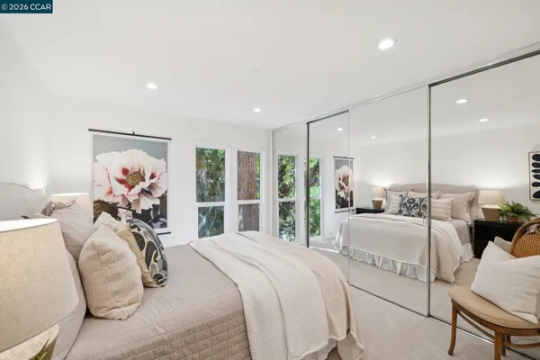 a bedroom with a large bed and a chandelier