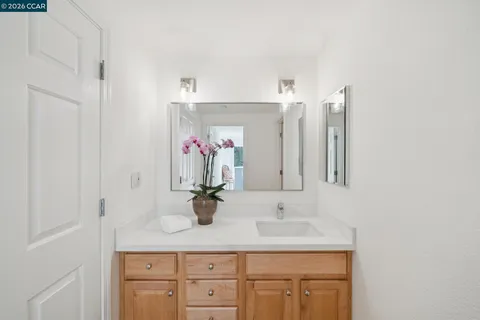a bathroom with a sink vanity and mirror