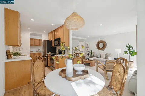 a dining room with wooden floor table and chairs