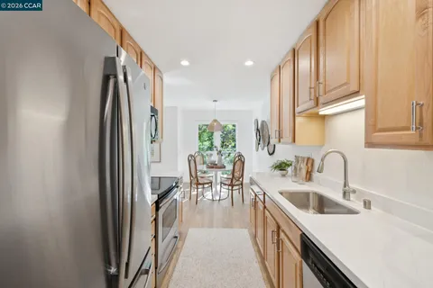 a kitchen with counter top space a sink and refrigerator