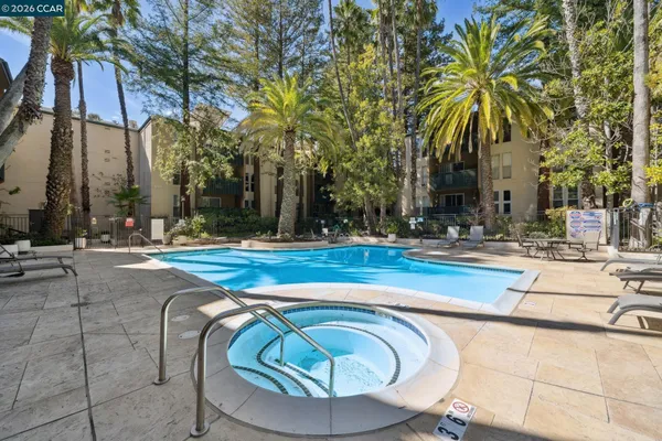 a swimming pool with outdoor seating and yard