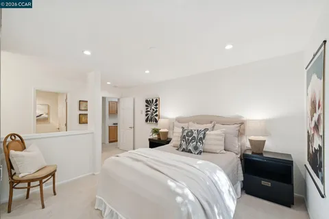 a bedroom with a bed and chair