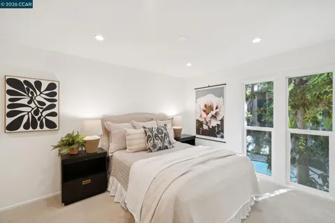 a bedroom with a bed and a painting on the wall