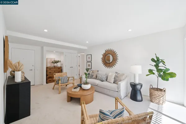 a living room with furniture and a potted plant