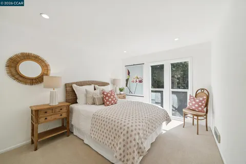 a bedroom with a bed a lamp and a window