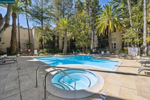 a swimming pool with outdoor seating and yard