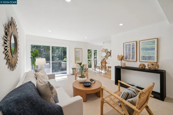 a living room with furniture and floor to ceiling windows