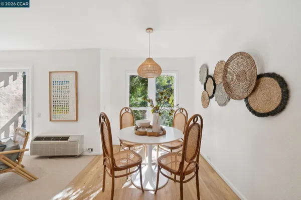 a dining room with furniture a chandelier and wooden floor