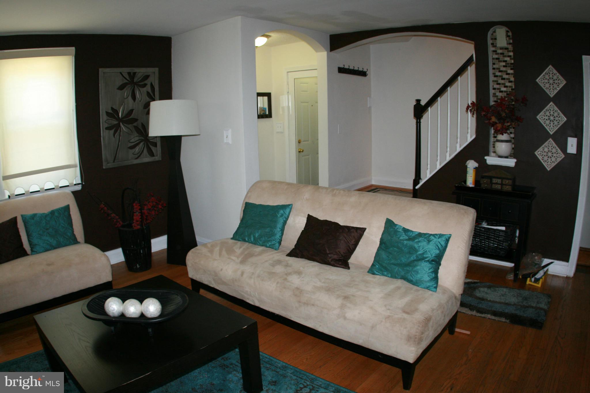 429 Academy Road Catonsville, MD 21228 - Photo 2 of 26 a living room with furniture and wooden floor
