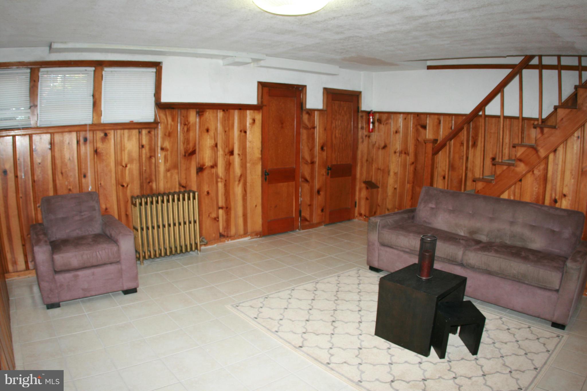 429 Academy Road Catonsville, MD 21228 - Photo 19 of 26 a stairs and a couch in a room