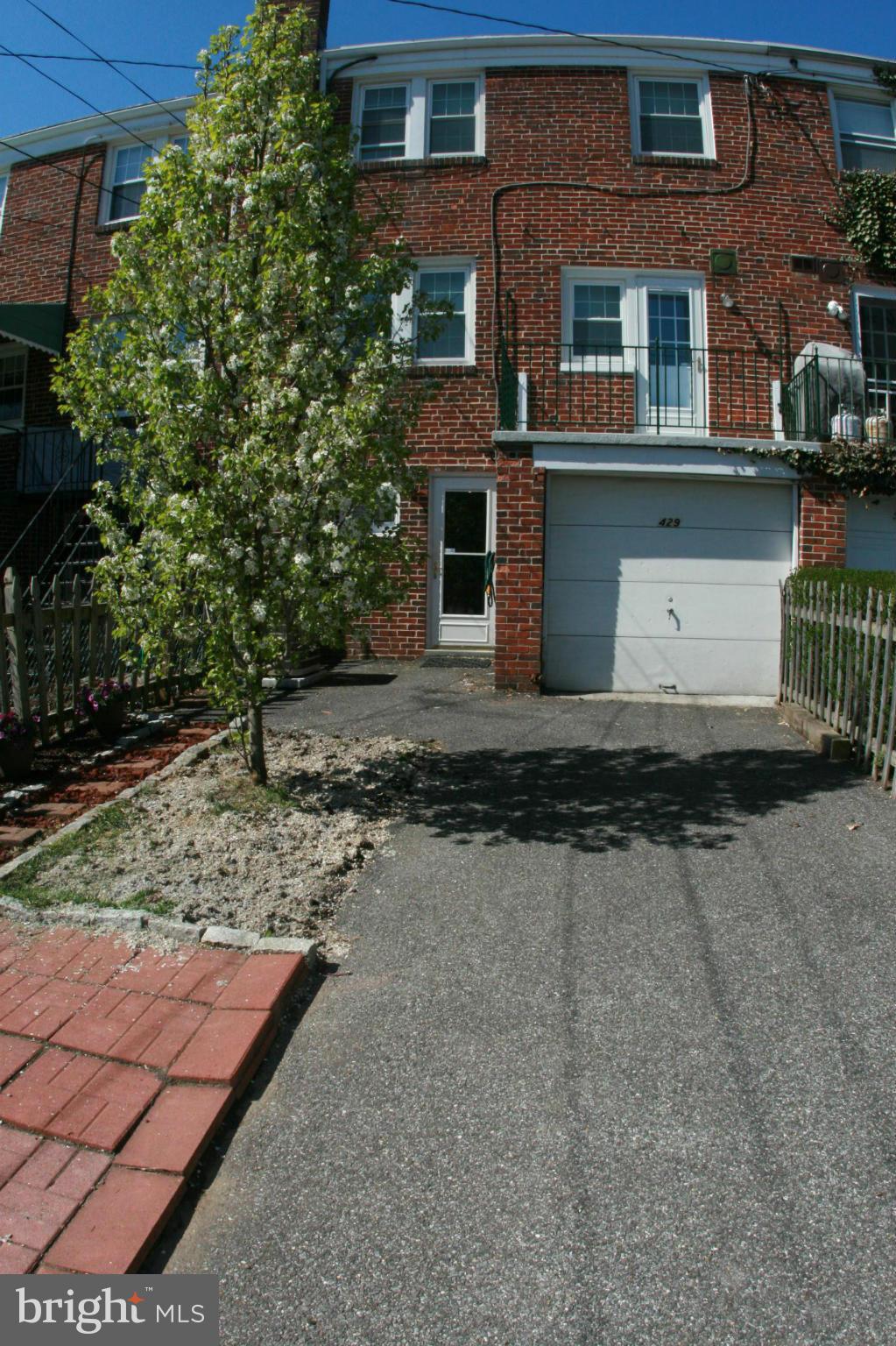 429 Academy Road Catonsville, MD 21228 - Photo 25 of 26 a front view of a house with a yard and a garage