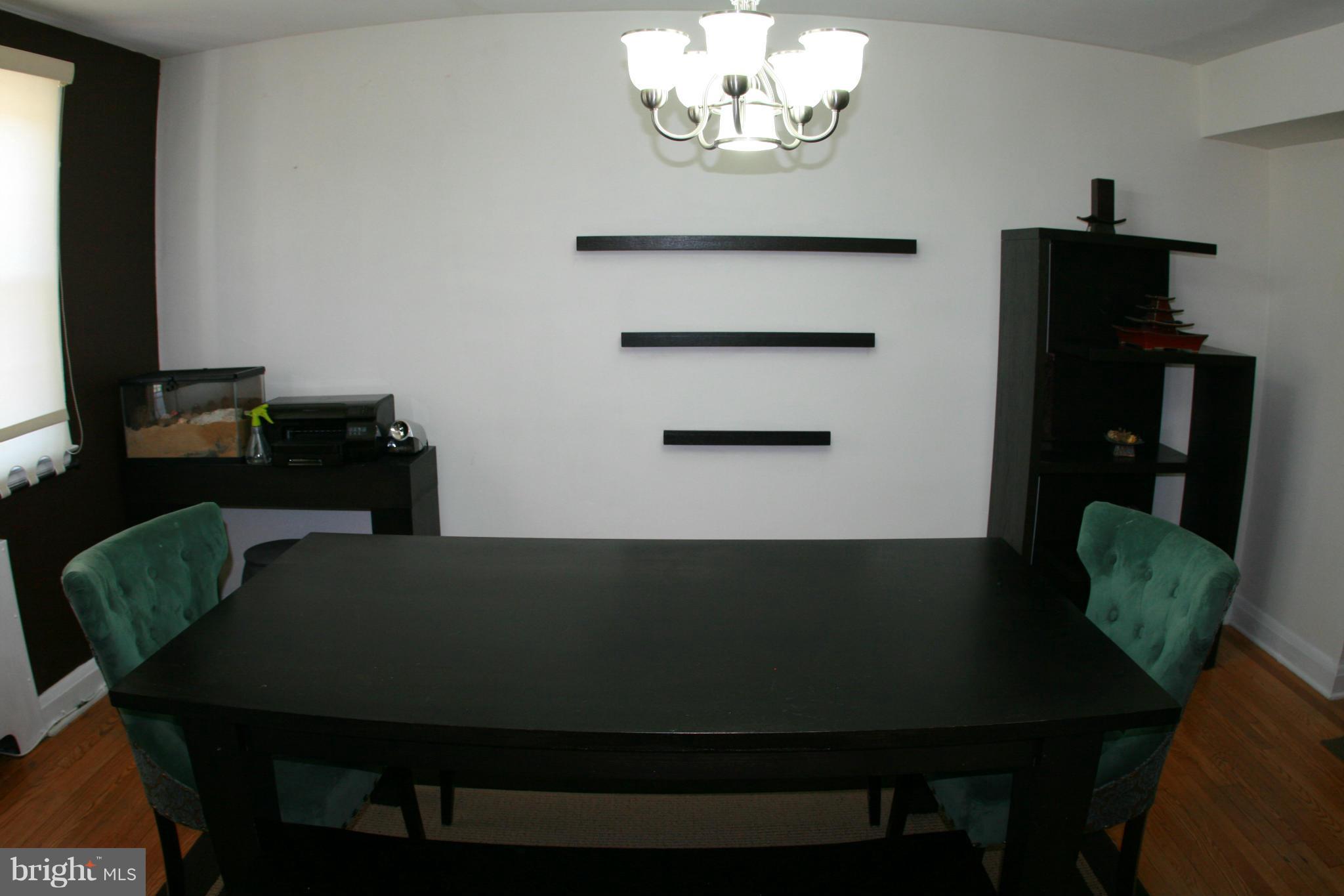 429 Academy Road Catonsville, MD 21228 - Photo 6 of 26 a view of a dining room with furniture and chandelier