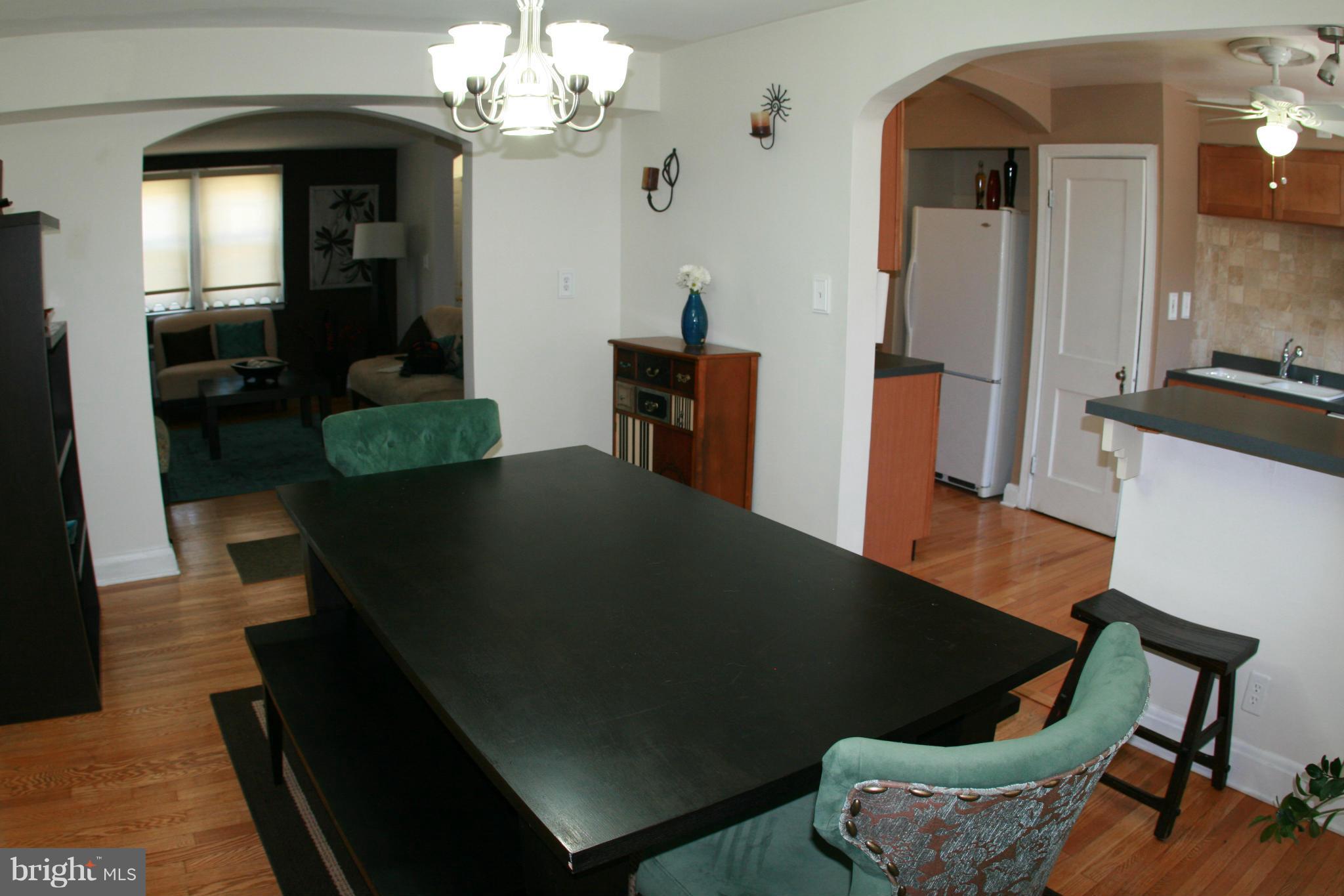 429 Academy Road Catonsville, MD 21228 - Photo 7 of 26 a living room with furniture and a chandelier