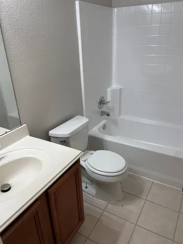 a bathroom with a sink a toilet and bathtub
