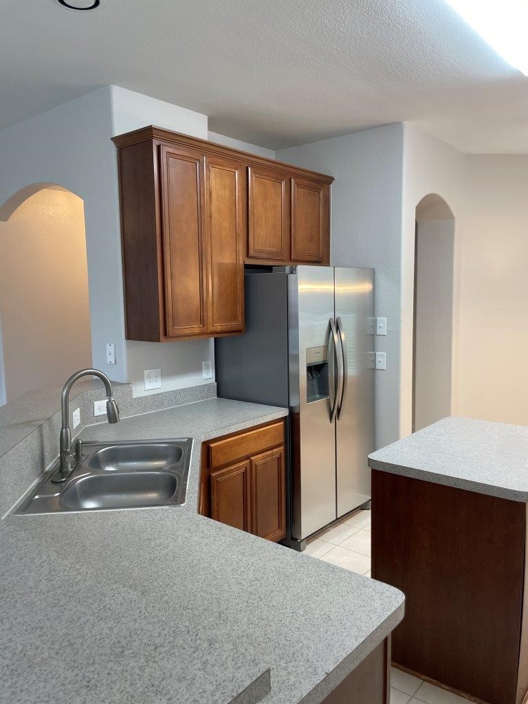 827 Chase View Drive Bacliff, TX 77518 - Photo 10 of 30 a kitchen with stainless steel appliances granite countertop a refrigerator and a sink