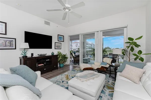 a bedroom with a bed table closet and a flat tv screen
