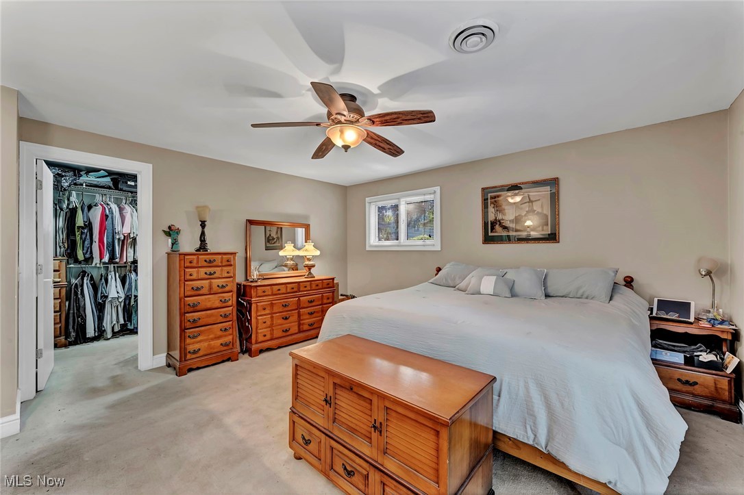 25915 Kennedy Ridge Road North Olmsted, OH 44070 - Photo 26 of 48 Bedroom featuring light carpet, a ceiling fan, and a walk in closet