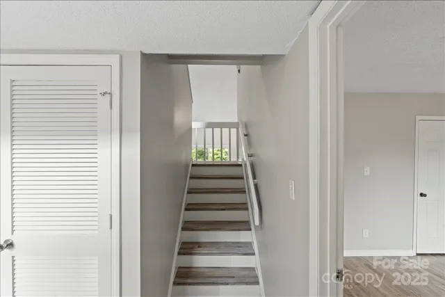 a view of a hallway with wooden floor and entryway