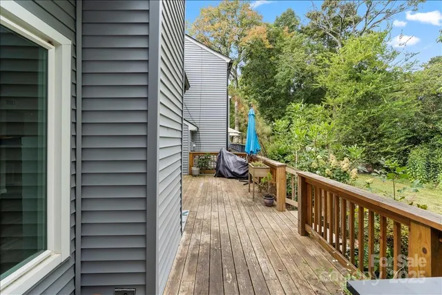 a view of balcony with wooden floor and fence