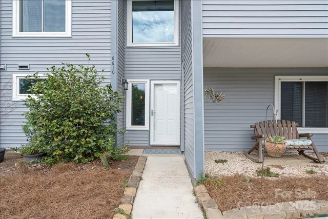 a wooden bench sitting in front of a house