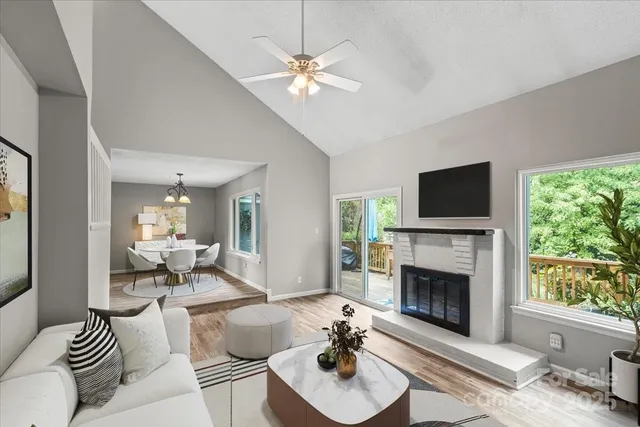 a living room with furniture a fireplace and a flat screen tv
