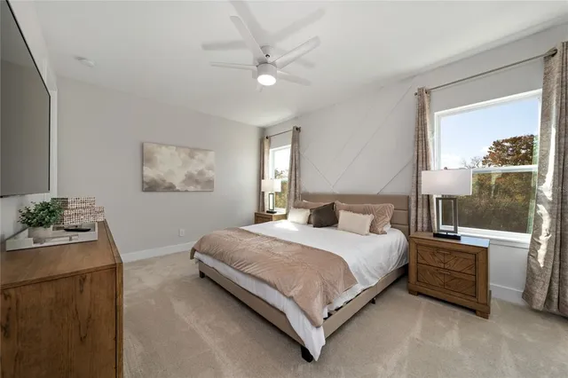 a bedroom with a bed table and window