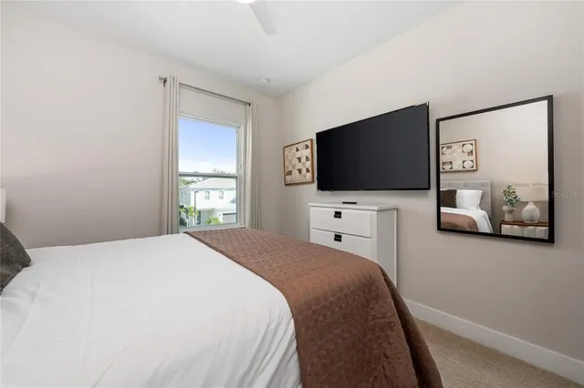 a bedroom with a flat screen tv and a bed