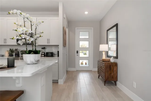 a kitchen with stainless steel appliances granite countertop a stove a sink dishwasher and a refrigerator with wooden floor