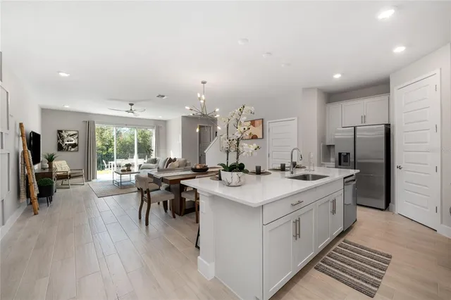 a kitchen with stainless steel appliances a sink stove and cabinets