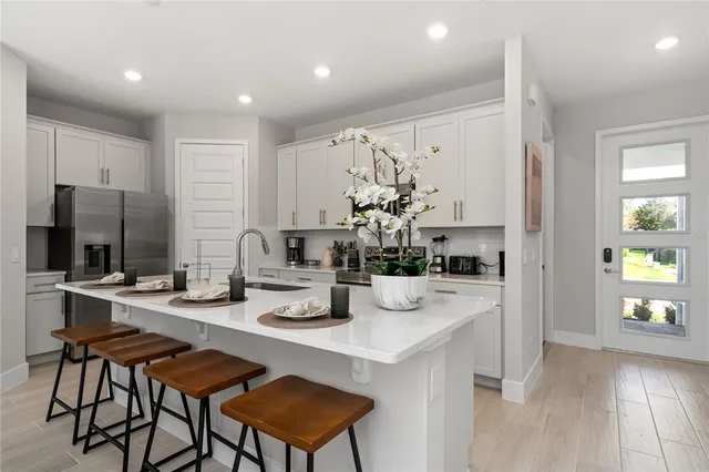a kitchen with a sink and chairs