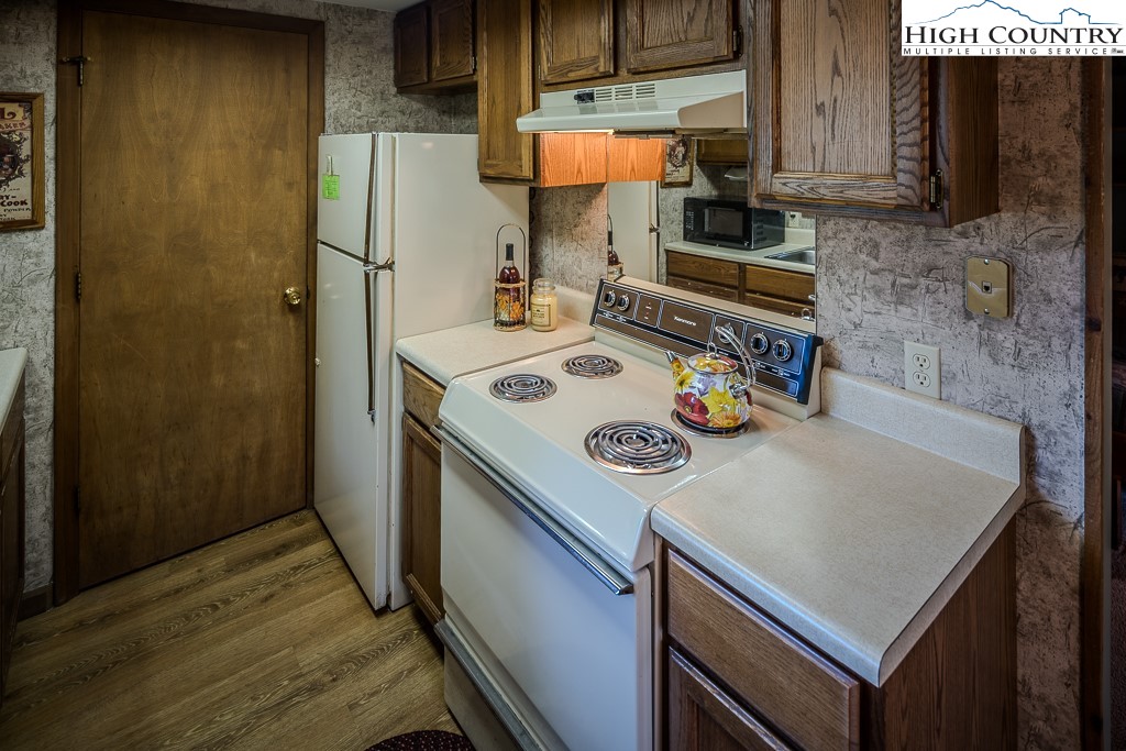 35 Maple Drive, Unit B Banner Elk, NC 28604 - Photo 11 of 21 a kitchen with a sink a stove and a refrigerator