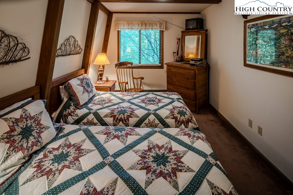 35 Maple Drive, Unit B Banner Elk, NC 28604 - Photo 19 of 21 a bedroom with a bed and large windows