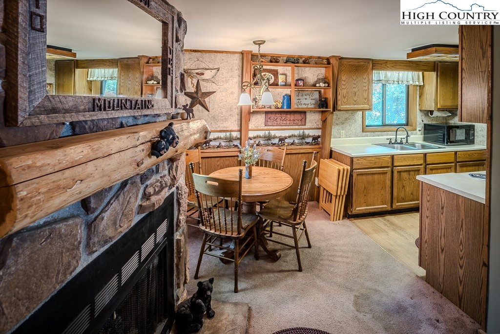 35 Maple Drive, Unit B Banner Elk, NC 28604 - Photo 7 of 21 a kitchen with stainless steel appliances granite countertop table chairs sink and cabinets