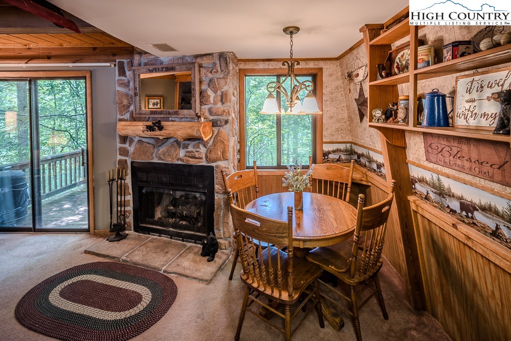 35 Maple Drive, Unit B Banner Elk, NC 28604 - Photo 9 of 21 a dining room with furniture and a fireplace