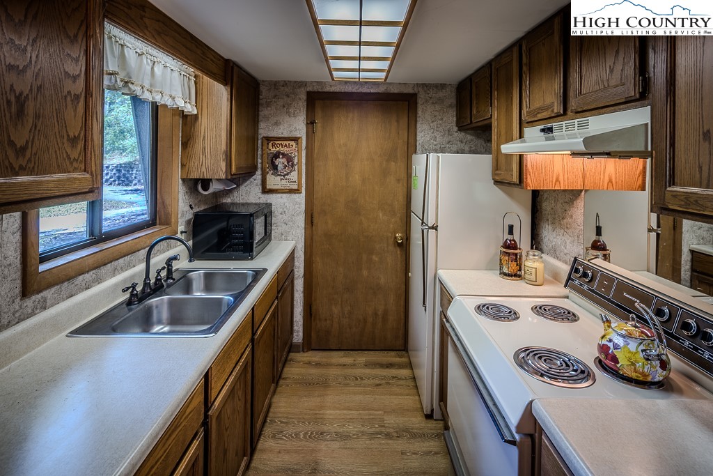 35 Maple Drive, Unit B Banner Elk, NC 28604 - Photo 10 of 21 a kitchen with a sink a stove and cabinets