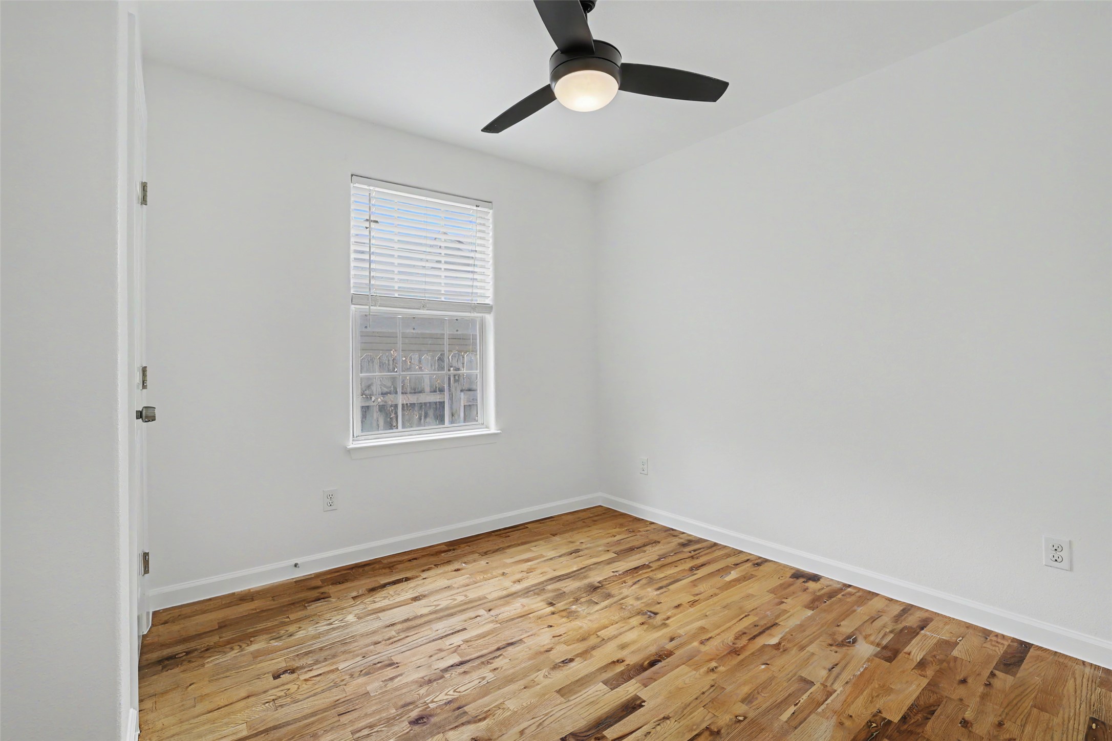 6307 Chesterfield Avenue Austin, TX 78752 - Photo 12 of 20 a view of empty room with wooden floor and fan