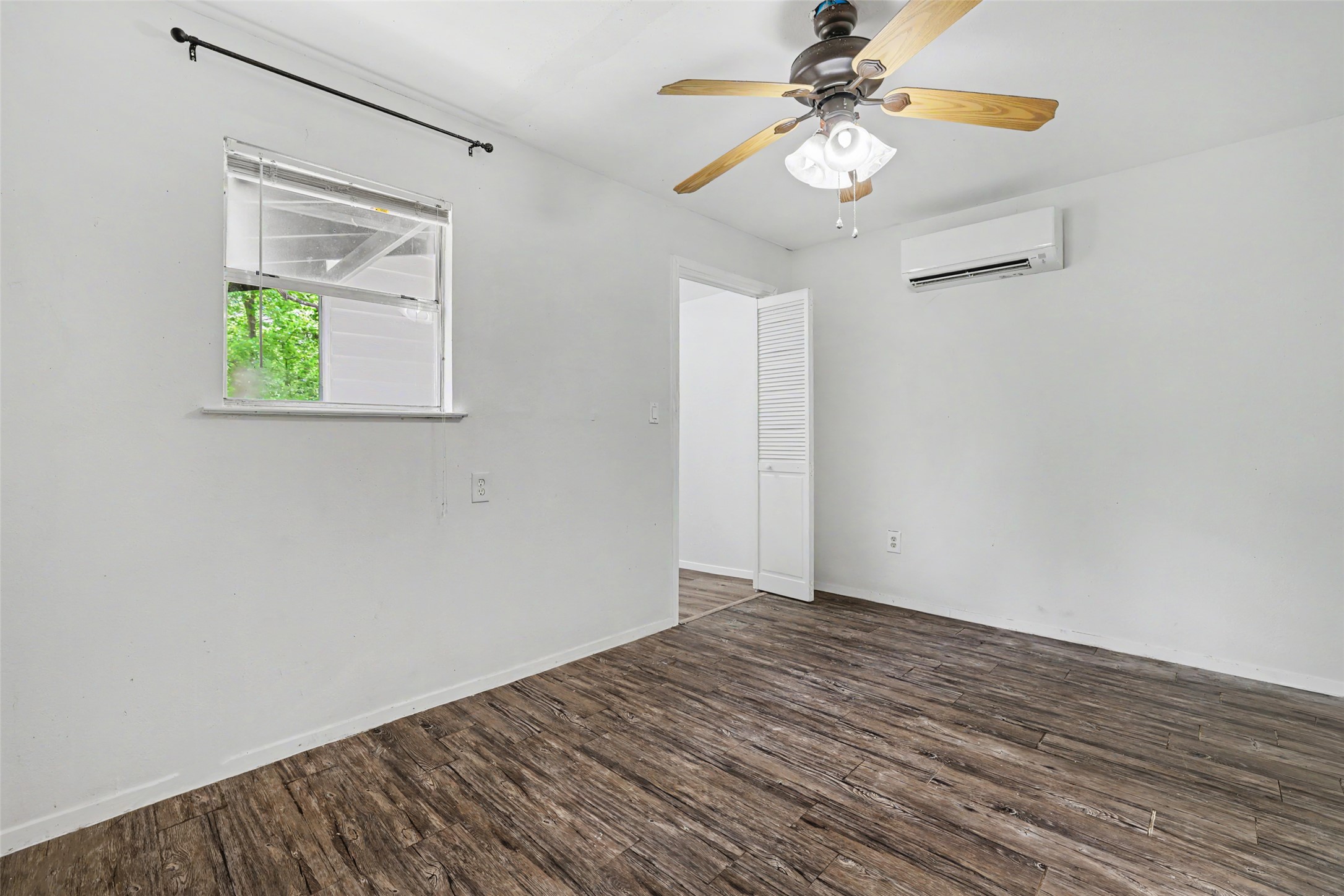 6307 Chesterfield Avenue Austin, TX 78752 - Photo 16 of 20 a view of an empty room with window and wooden floor