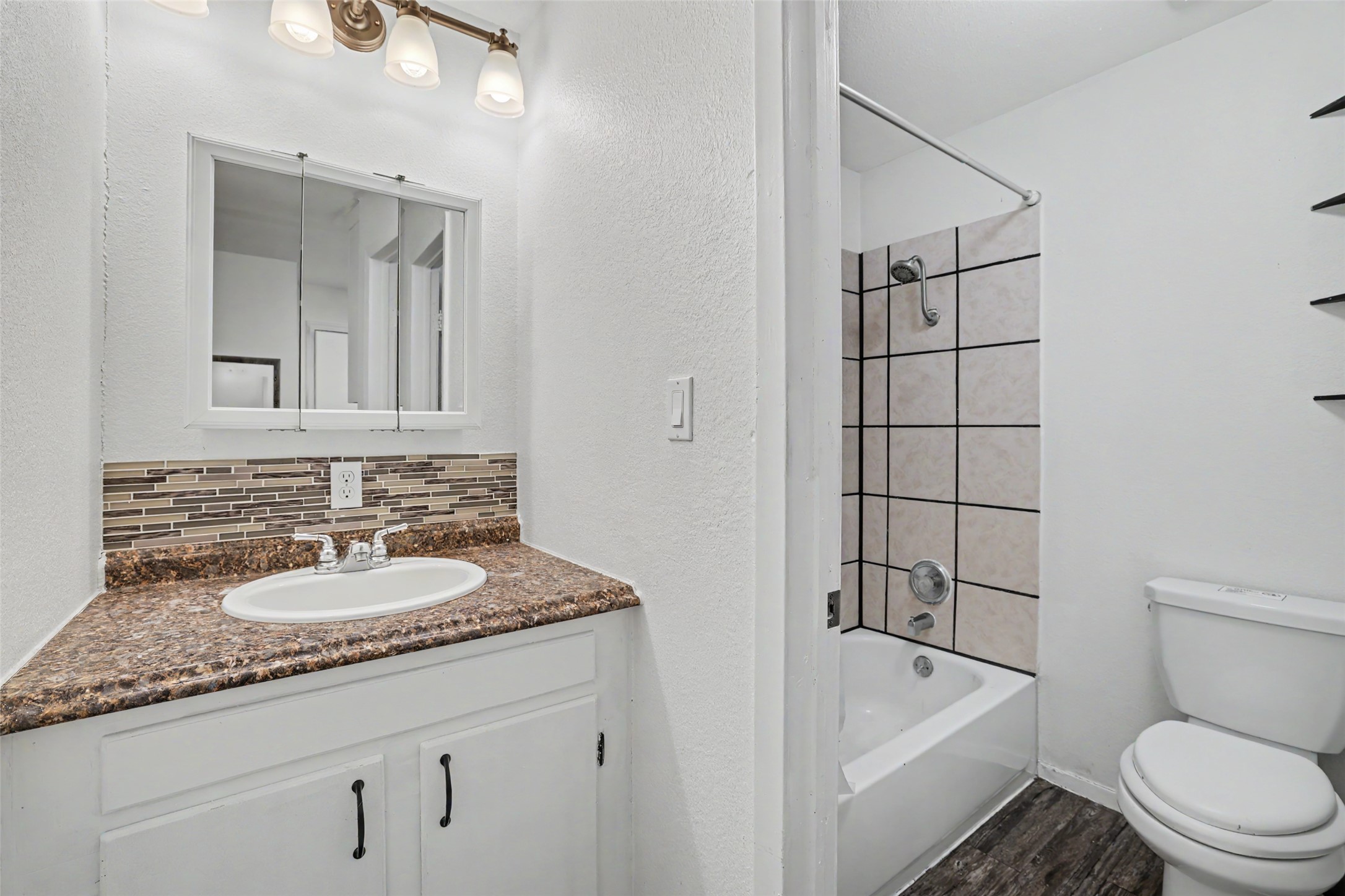 6307 Chesterfield Avenue Austin, TX 78752 - Photo 18 of 20 a bathroom with a granite countertop sink toilet and shower