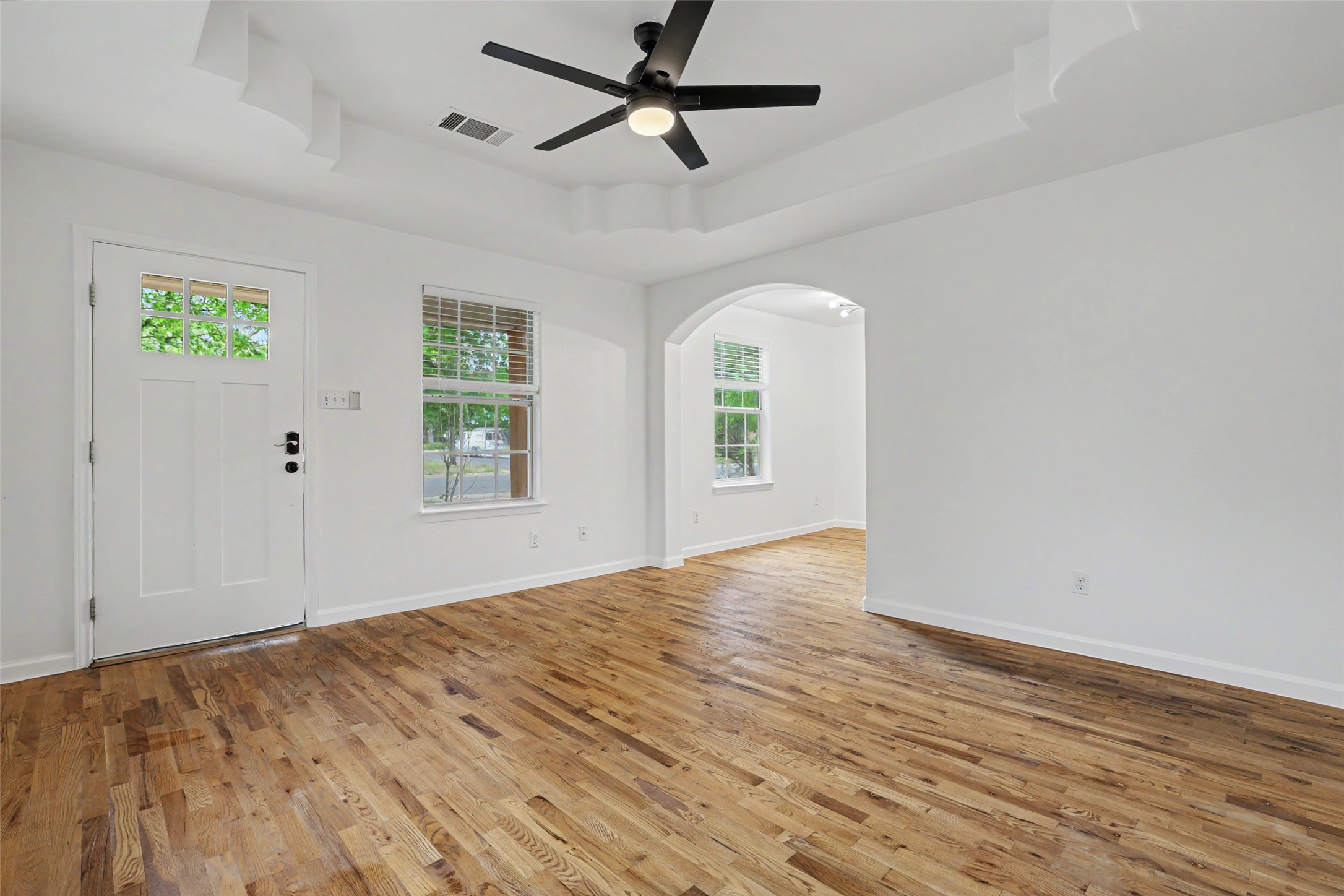 6307 Chesterfield Avenue Austin, TX 78752 - Photo 2 of 20 a view of empty room with wooden floor and fan