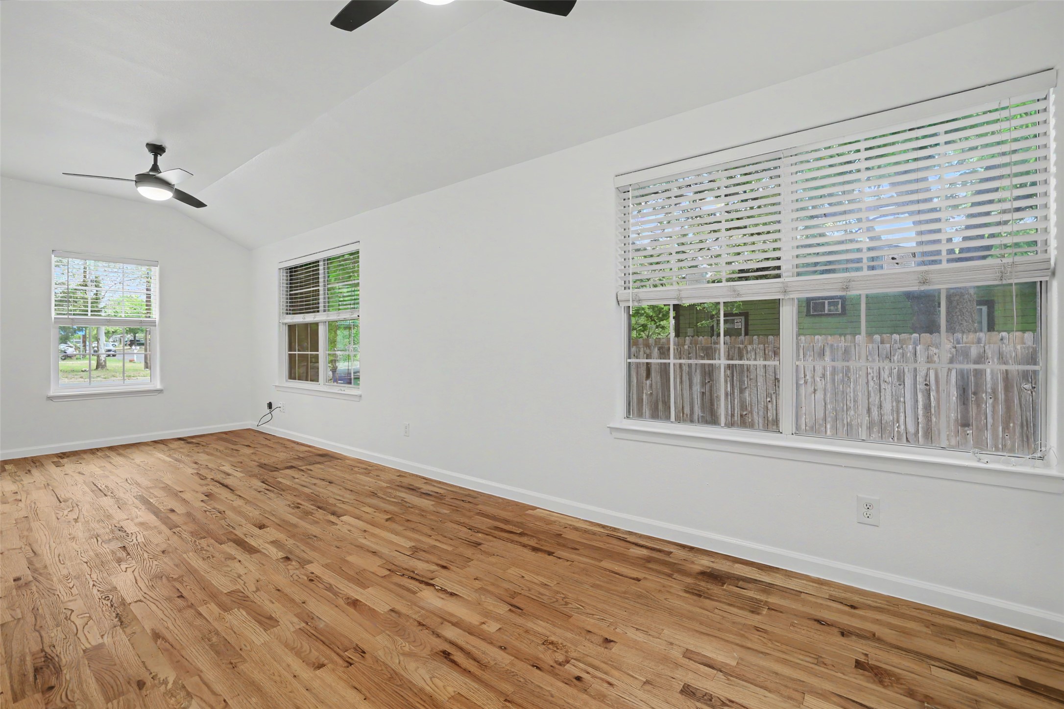6307 Chesterfield Avenue Austin, TX 78752 - Photo 6 of 20 a view of an empty room with a window and wooden floor