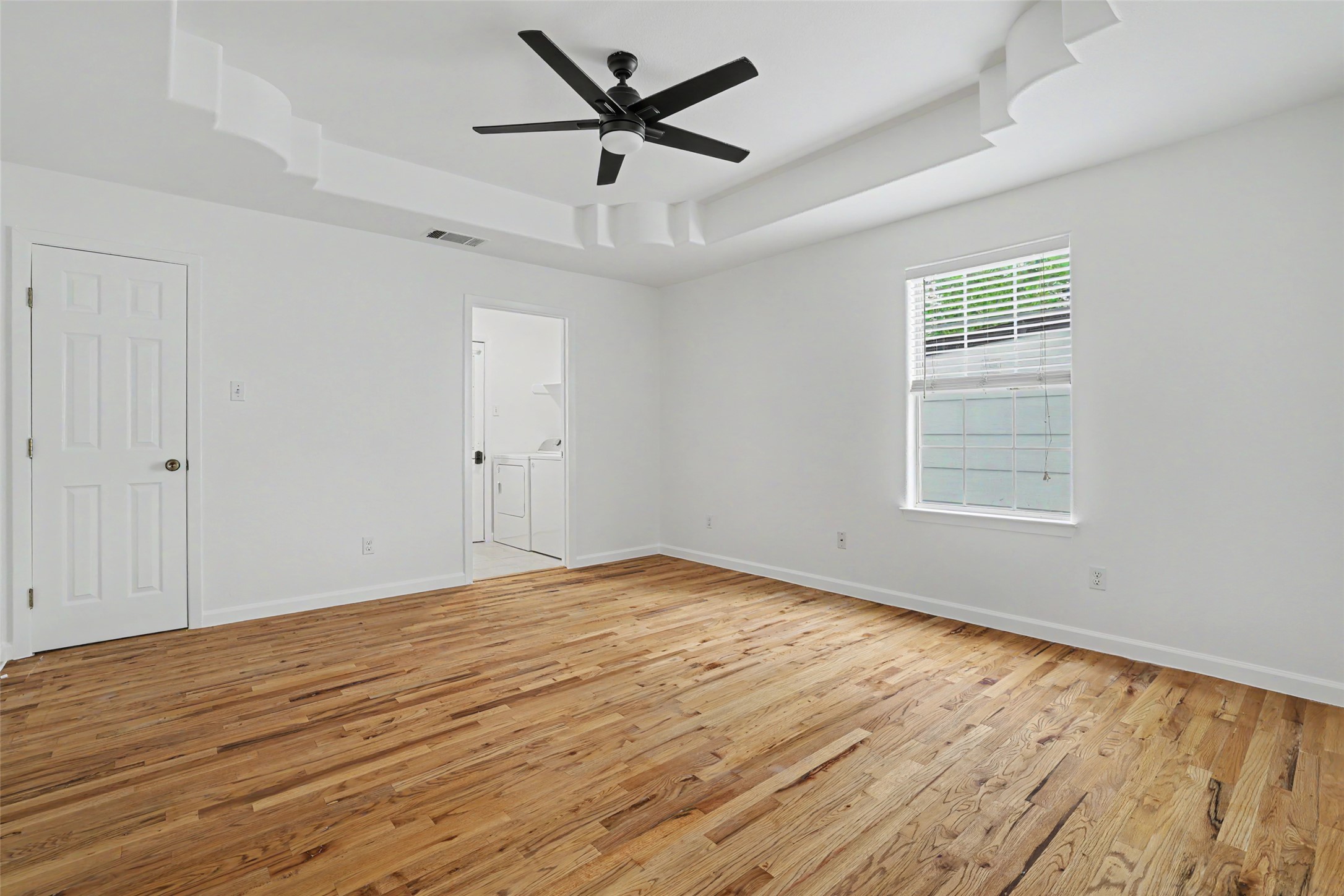 6307 Chesterfield Avenue Austin, TX 78752 - Photo 8 of 20 a view of empty room with wooden floor and fan