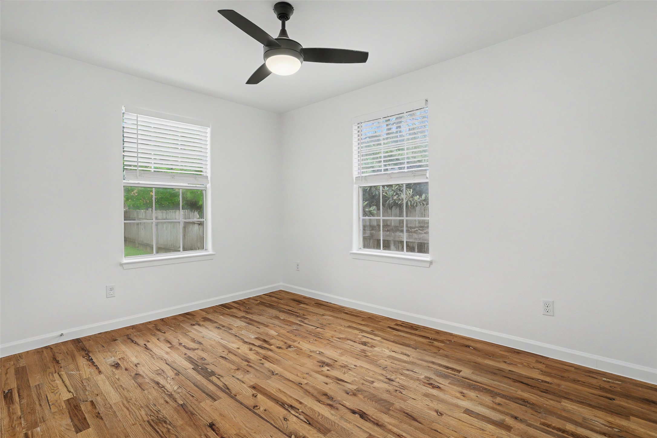 6307 Chesterfield Avenue Austin, TX 78752 - Photo 10 of 20 a view of an empty room with wooden floor and a window