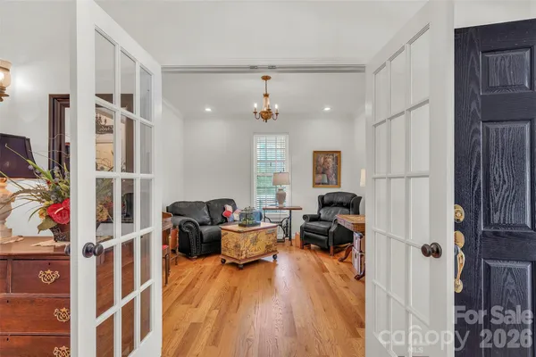 a living room with furniture windows and a chandelier
