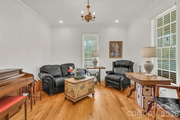a living room with furniture a rug and a window