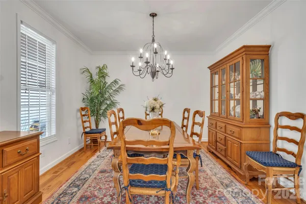 a view of a dining room with furniture and a chandelier