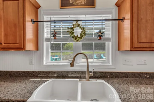 a kitchen with granite countertop a sink and a window